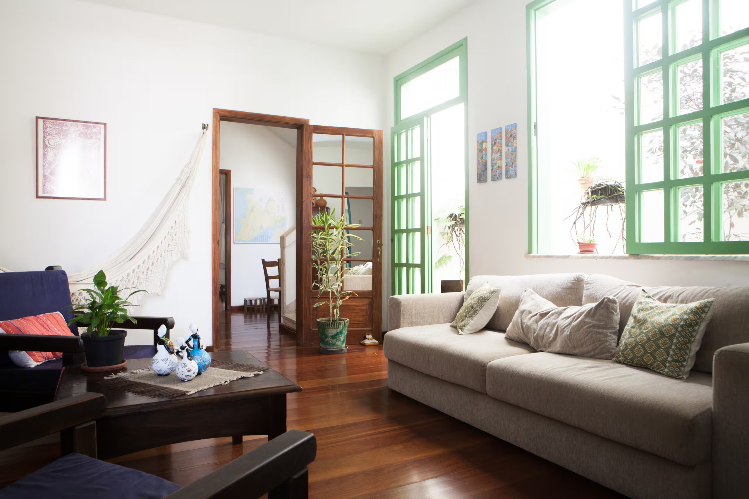 Casa Zelina salon with green windows and hammock